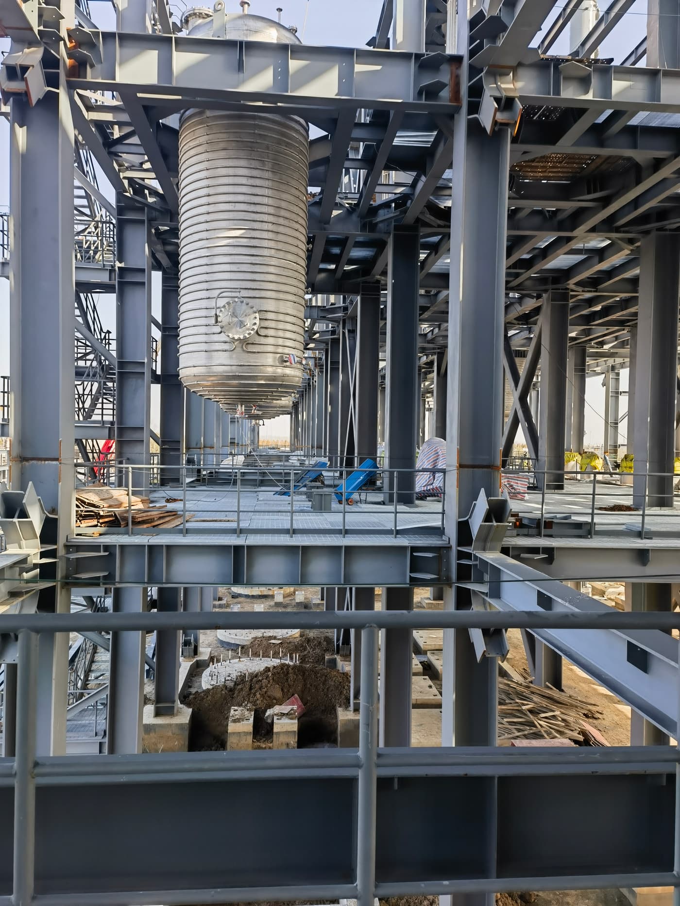 Grating walkway installed through process equipment steelwork