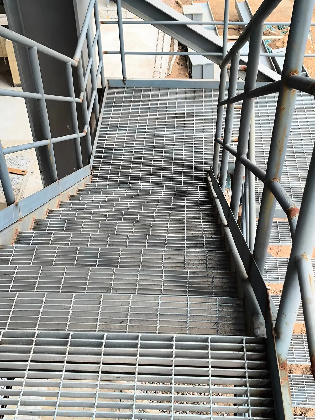 Galvanized steel grating stair and landing in a chemical process structure