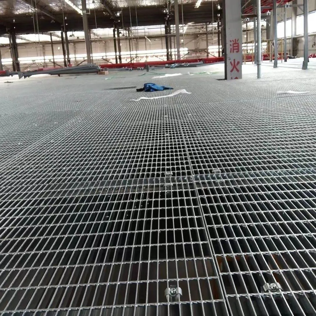 Steel grating floor panels being installed across an industrial building