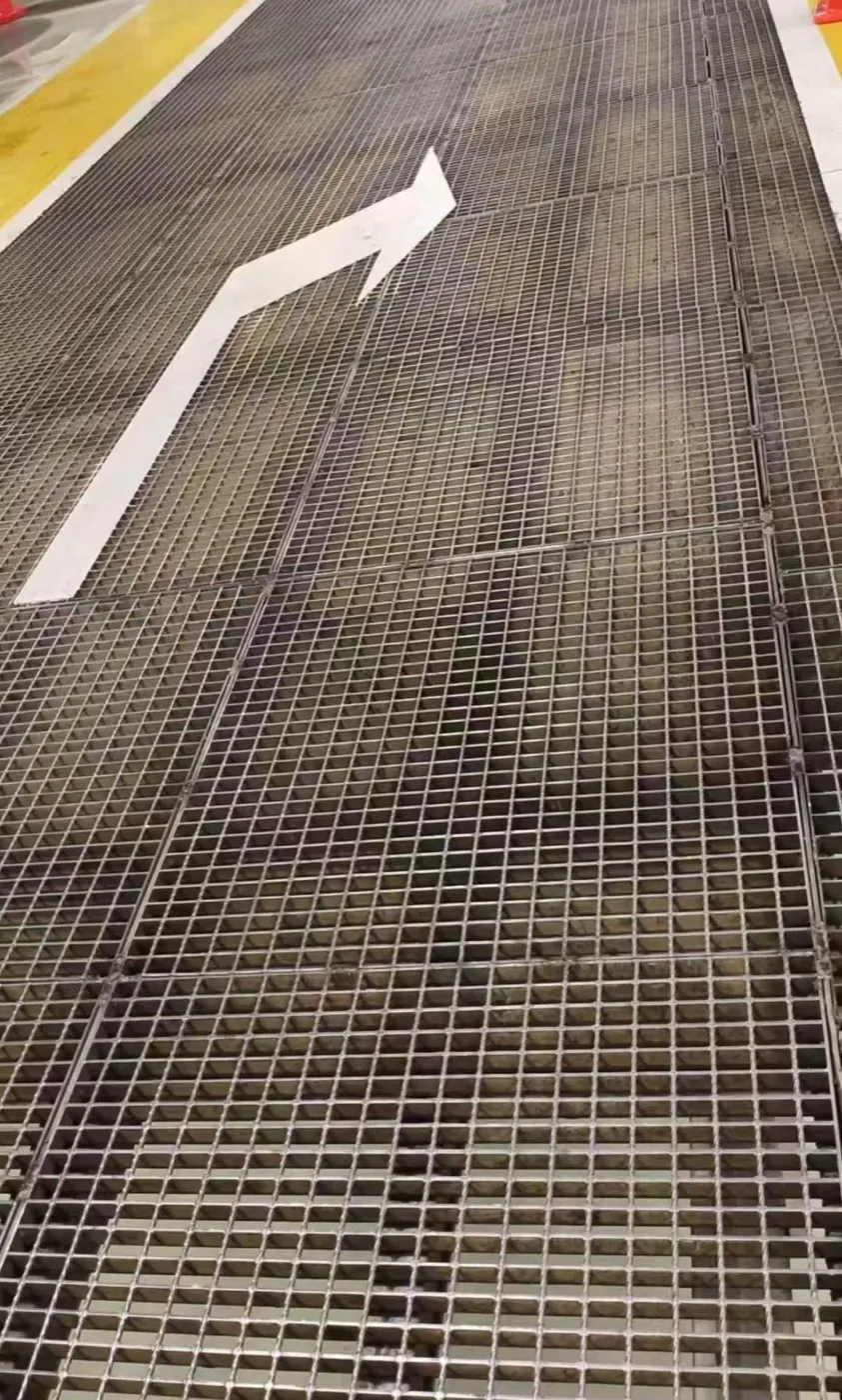 Industrial steel grating floor with a marked pedestrian route