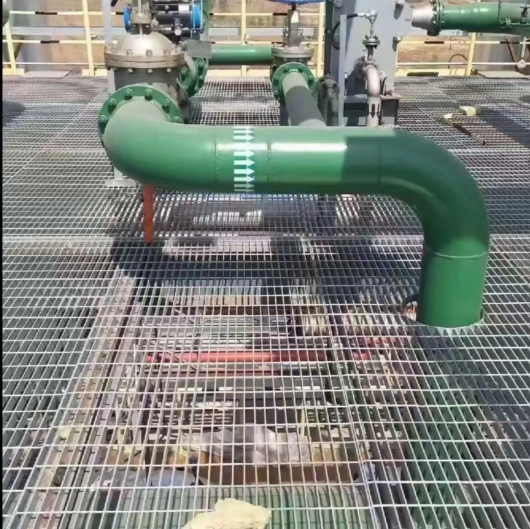 Steel grating flooring around industrial pipe equipment