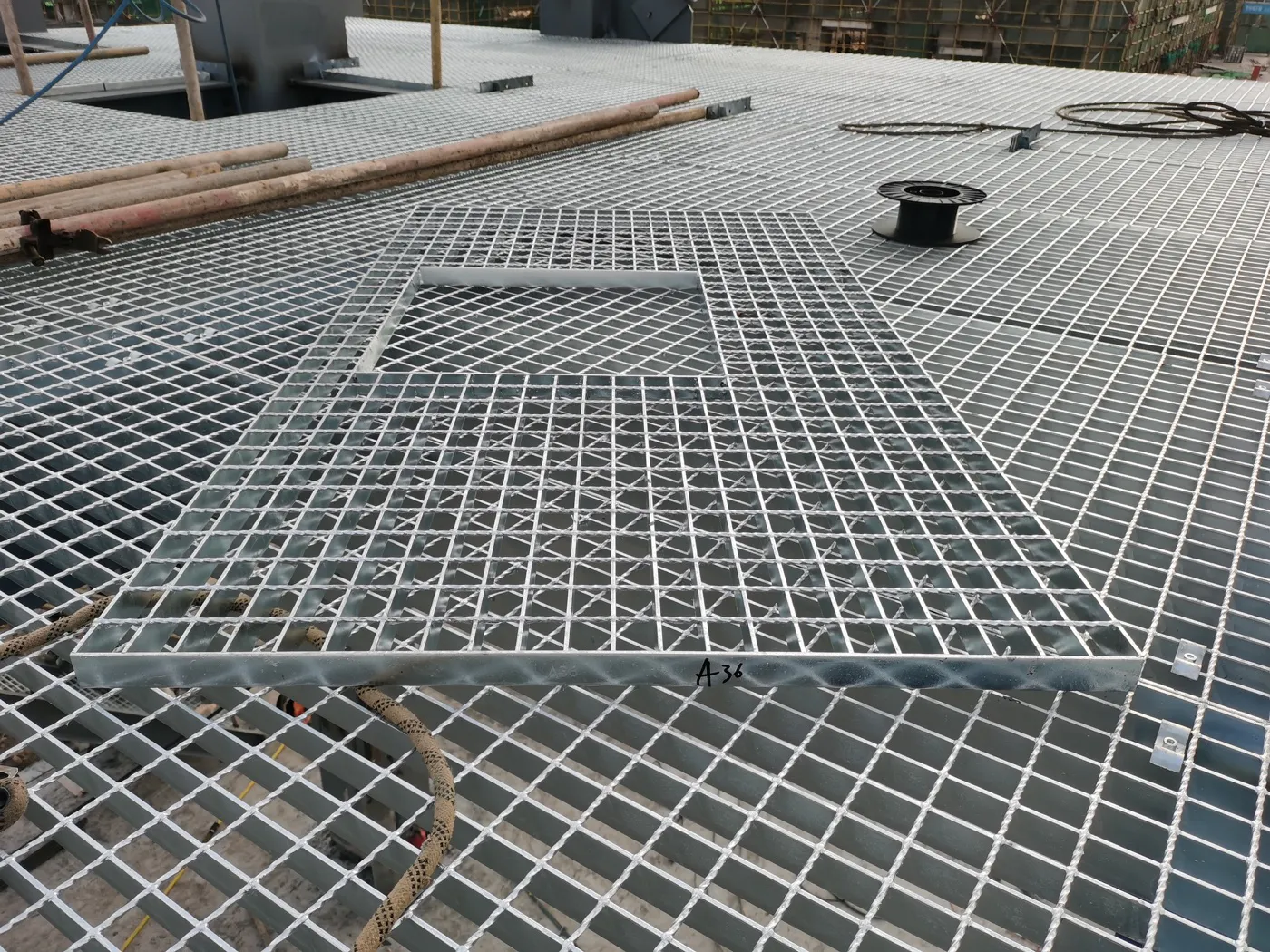 Custom-cut steel grating panels fitted around platform equipment