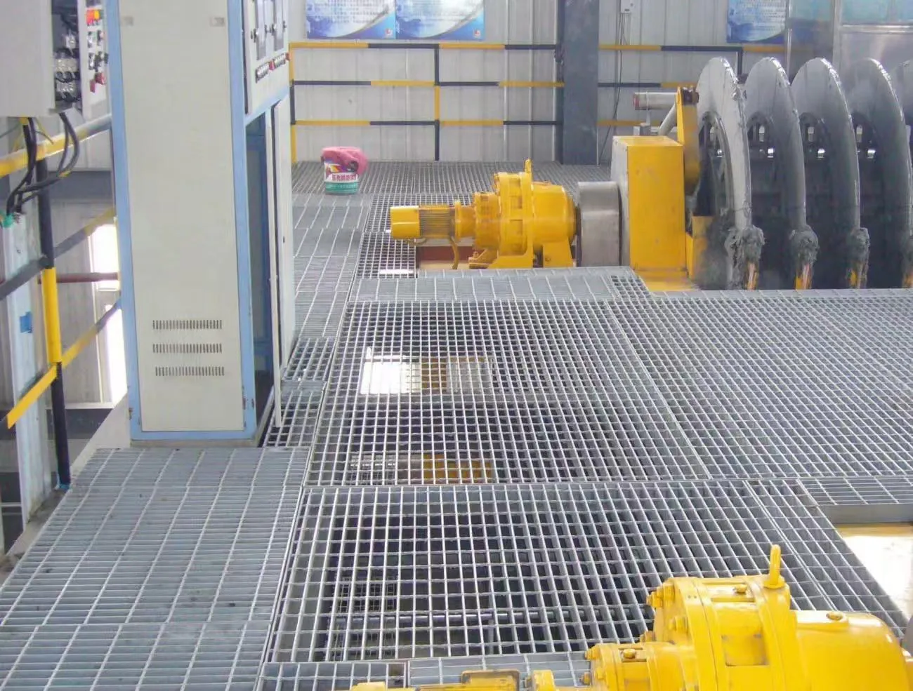 Steel grating operating platform beside industrial machinery