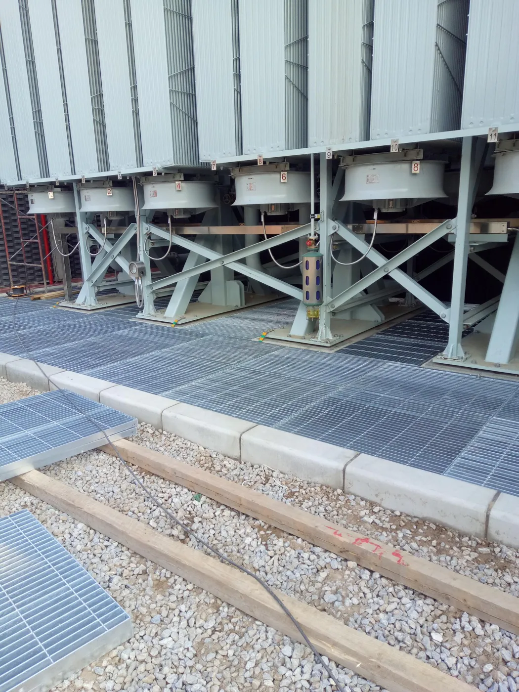 Large steel grating platform serving industrial equipment