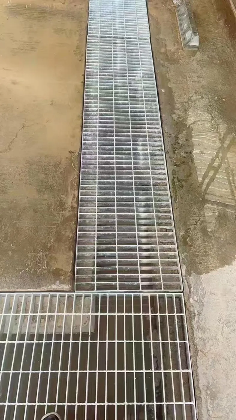 Indoor steel grating drain cover fitted around a corner