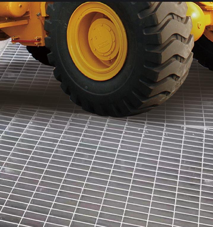 Loader tire on heavy-duty grating industrial flooring