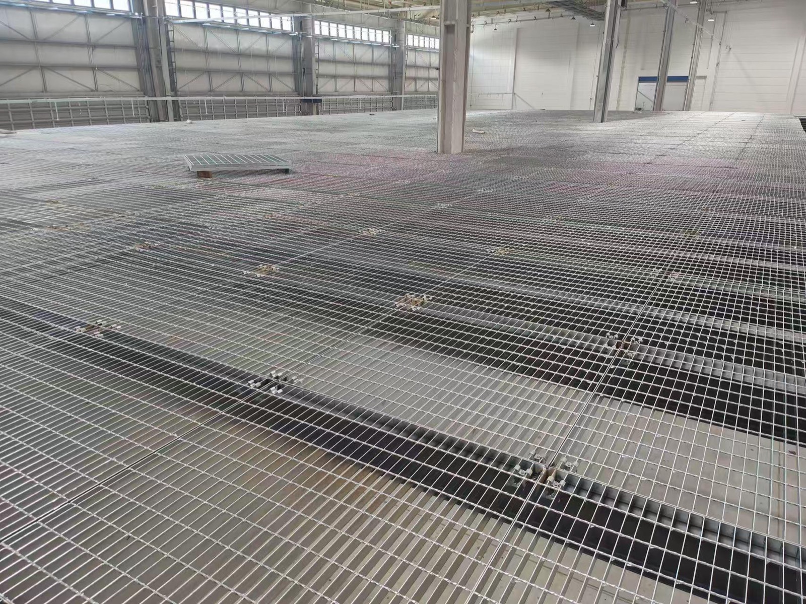 Expansive industrial grating floor installed inside a processing facility