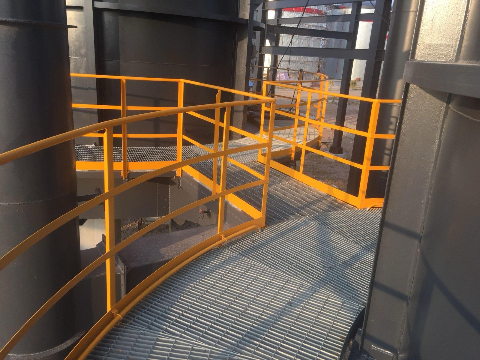 Galvanized steel grating platform around industrial process equipment