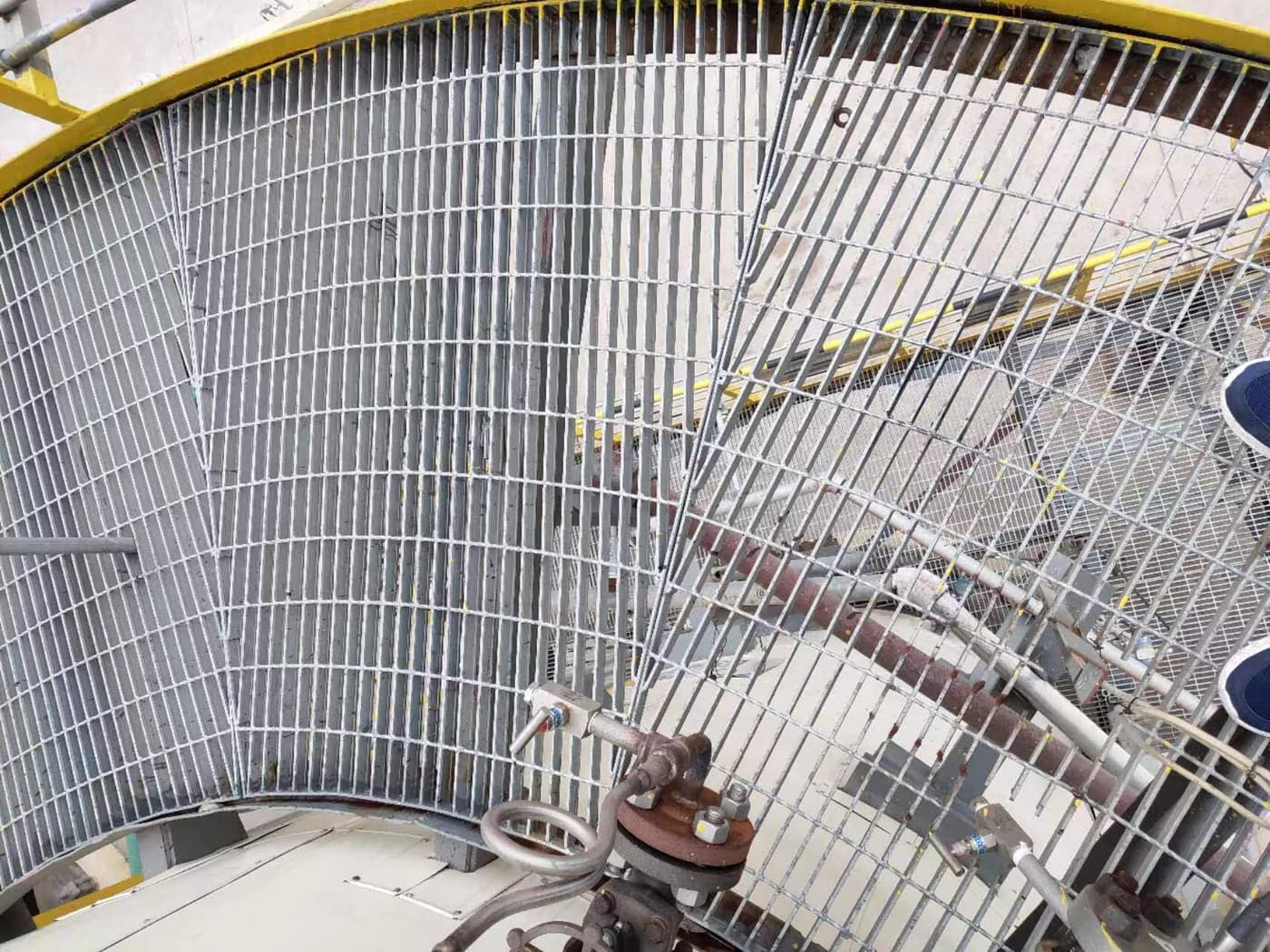 Interior view of curved grating panels fitted around tower equipment