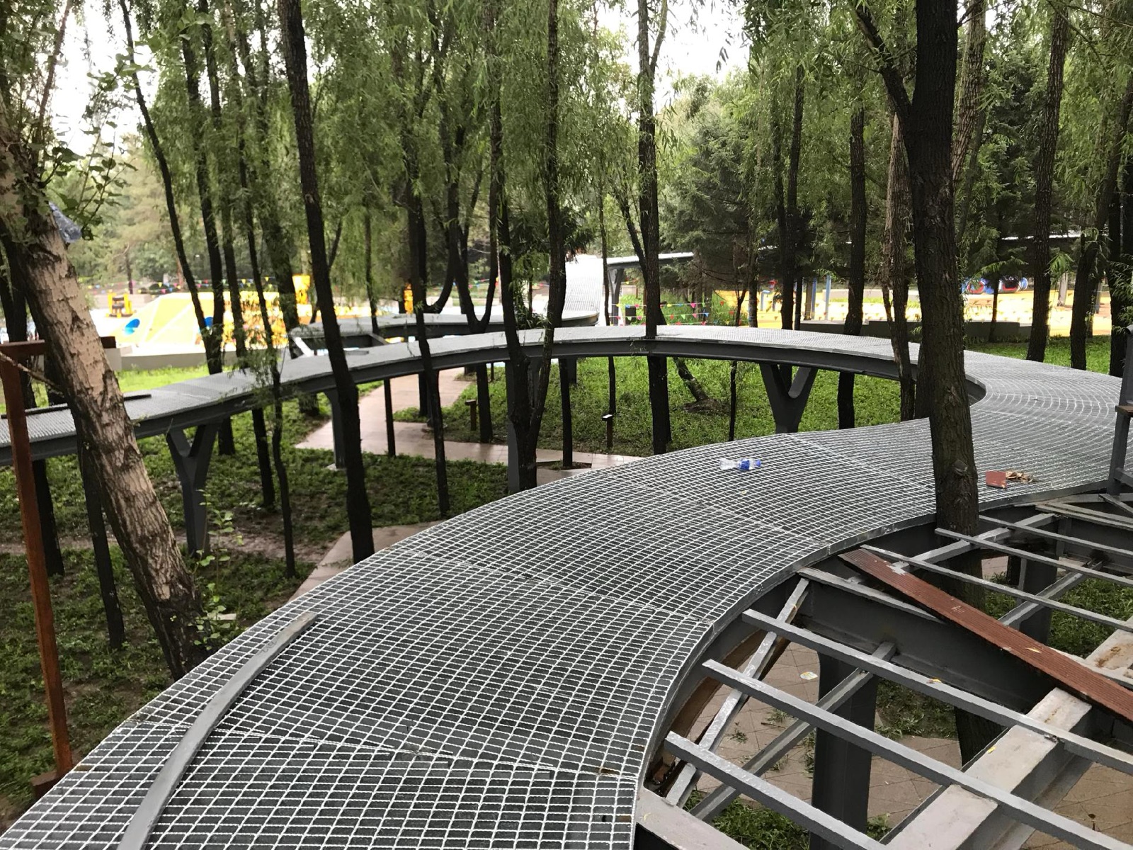 Elevated steel grating walkway with safety railings