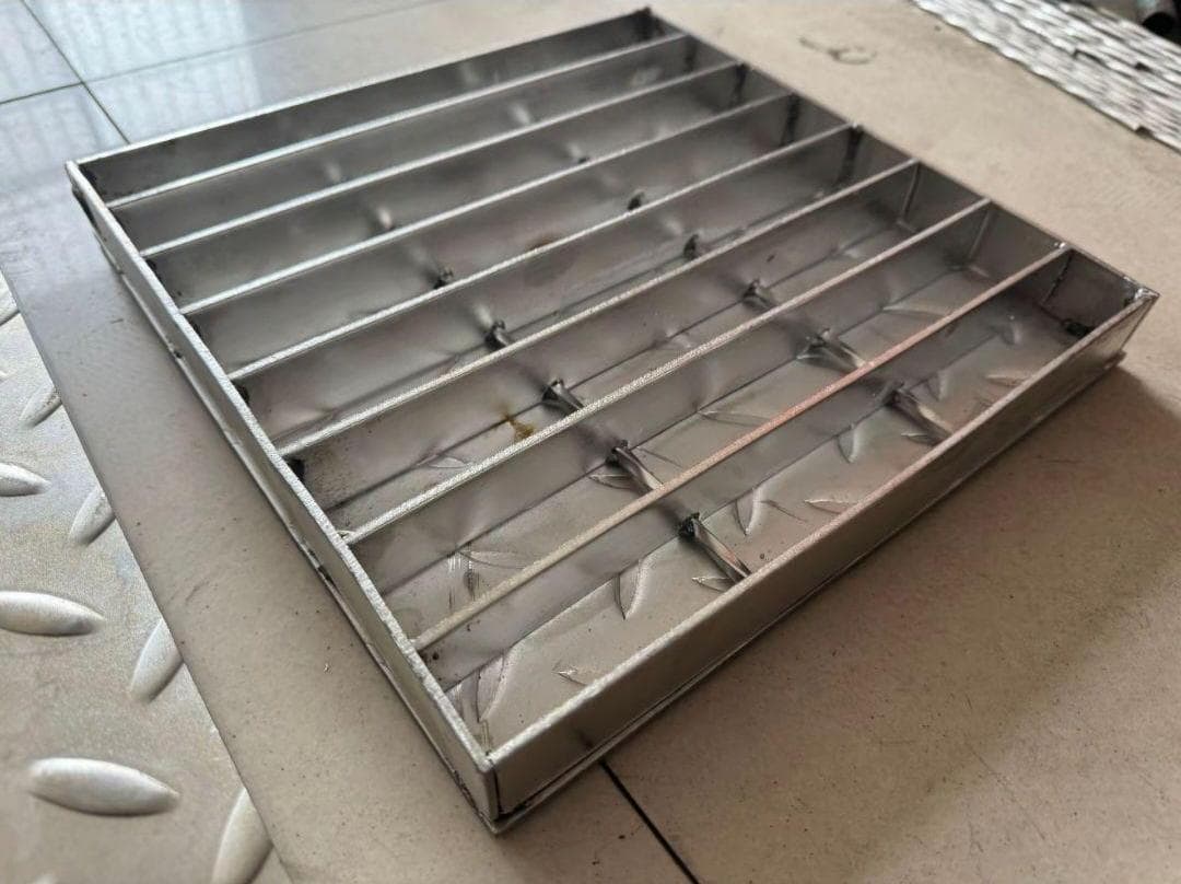 Underside of a compound panel showing the plate attached to bearing bars