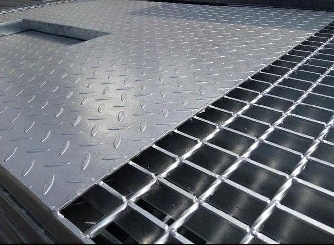 Close view of checkered plate ending beside an open grating section