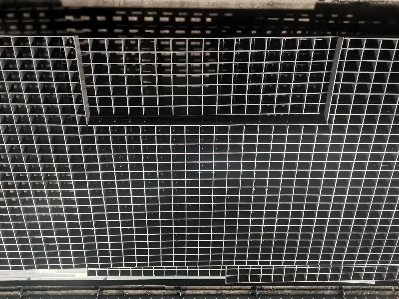 Fabricated grating panel with multiple rectangular openings and perimeter banding