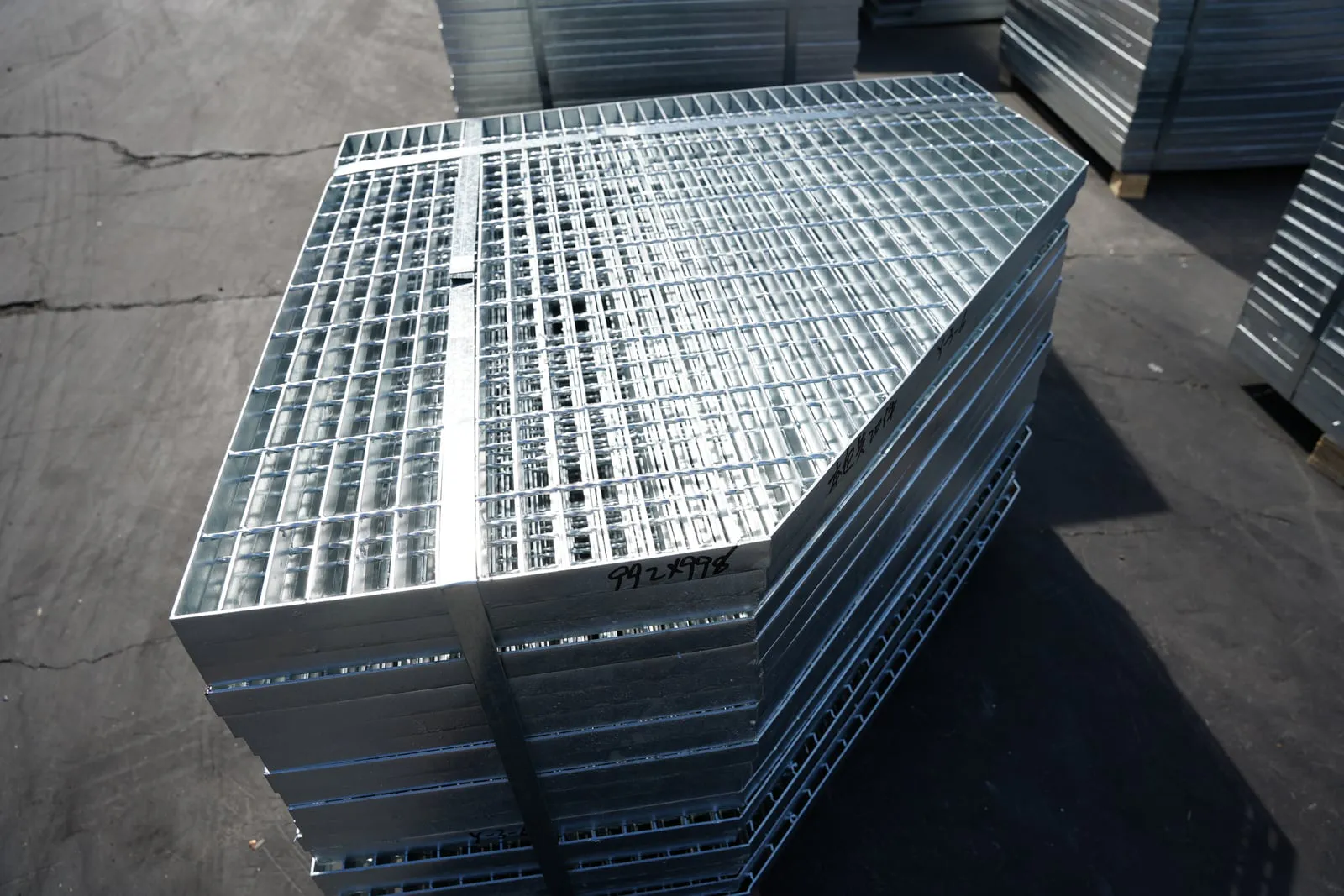 Stacked trapezoidal steel grating panels prepared in the workshop