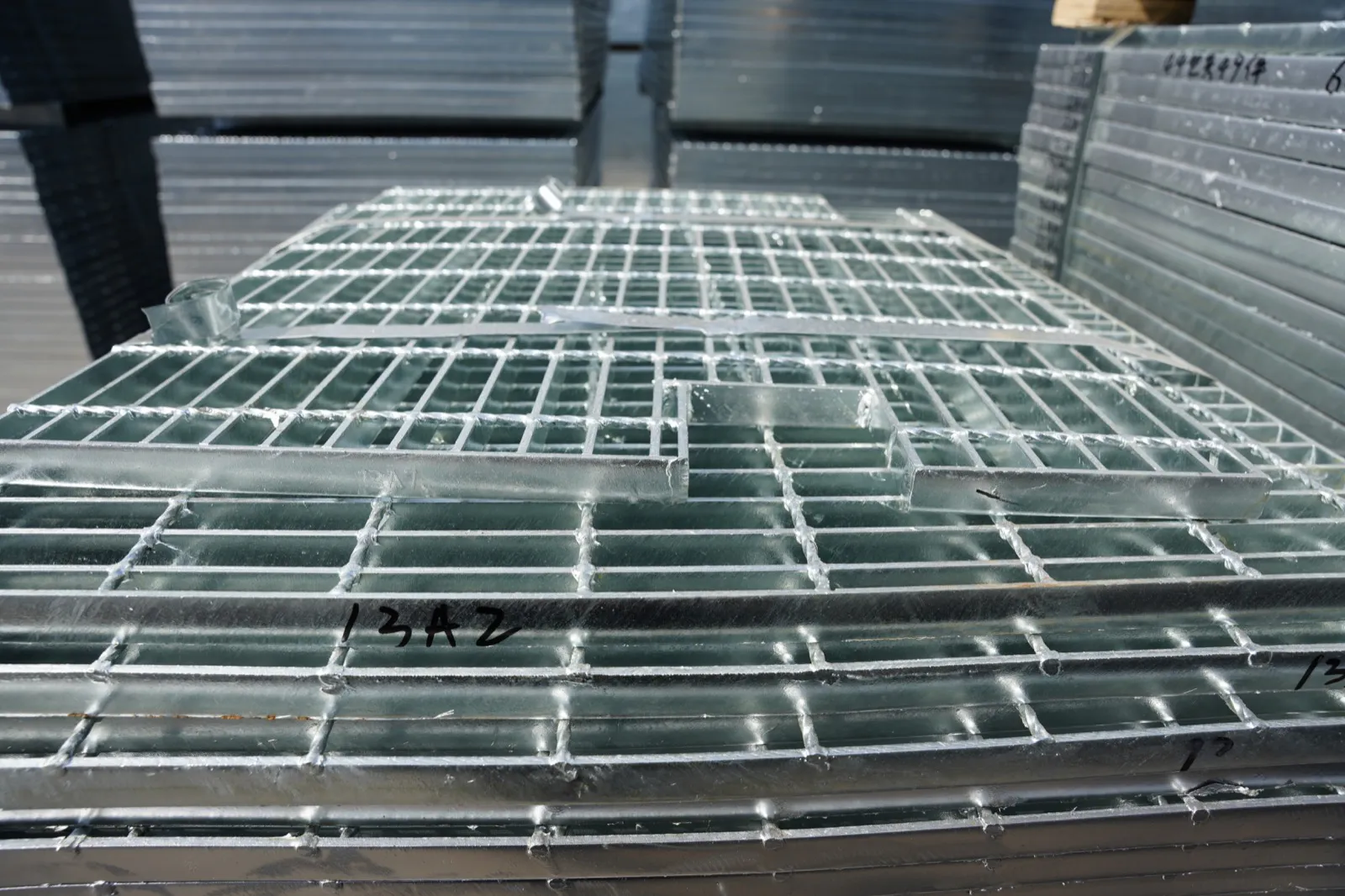Galvanized welded steel grating panels arranged in the workshop