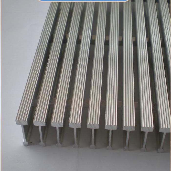 Ends of aluminum I-shaped bearing bars showing flange and narrow web