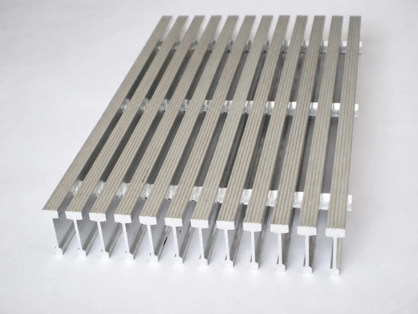 Complete aluminum grating panel with I-shaped bearing bars shown end-on