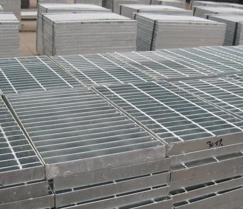 Stacks of finished press-locked grating panels arranged for workshop handling