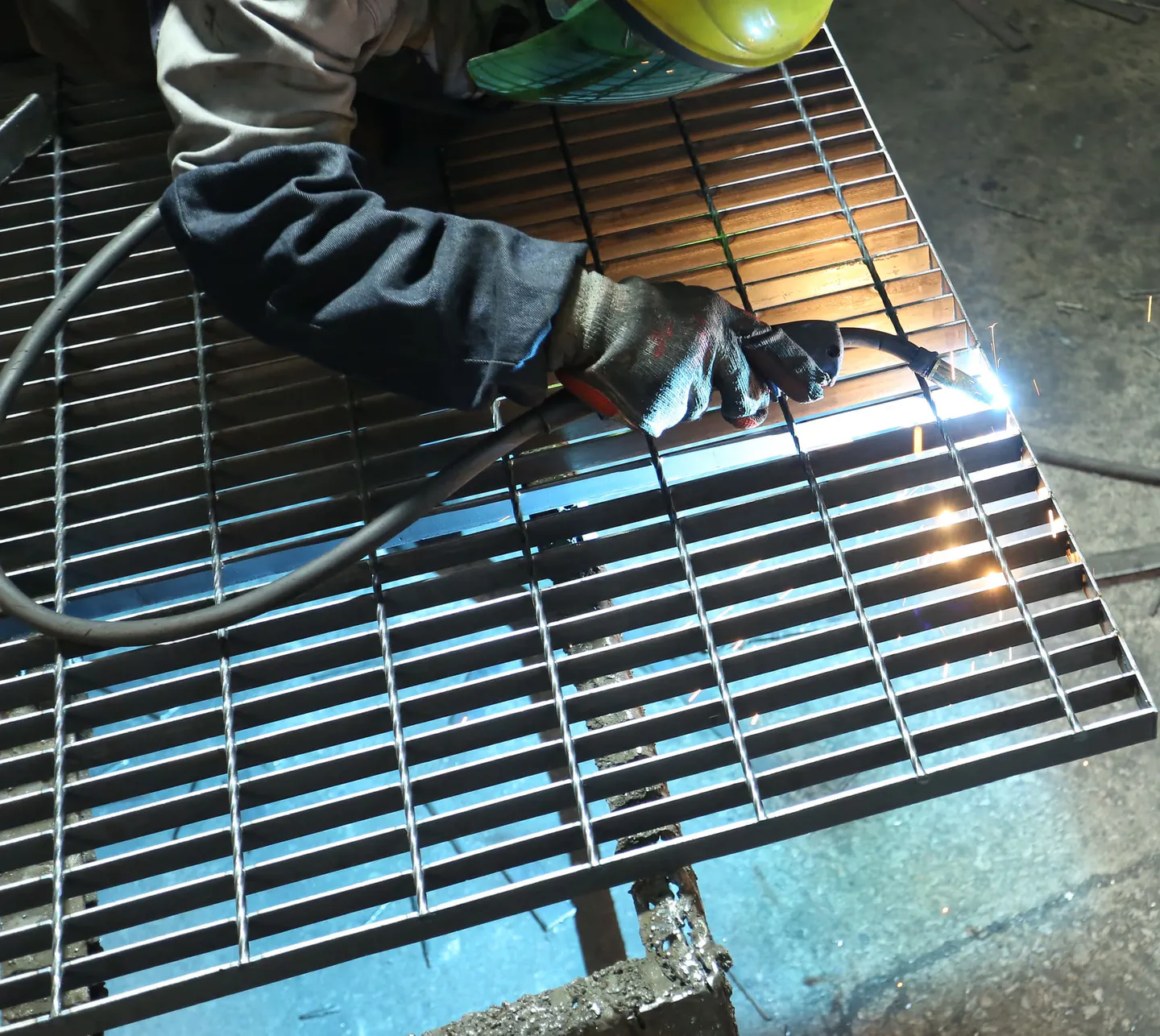 Welding work on a custom welded steel grating panel