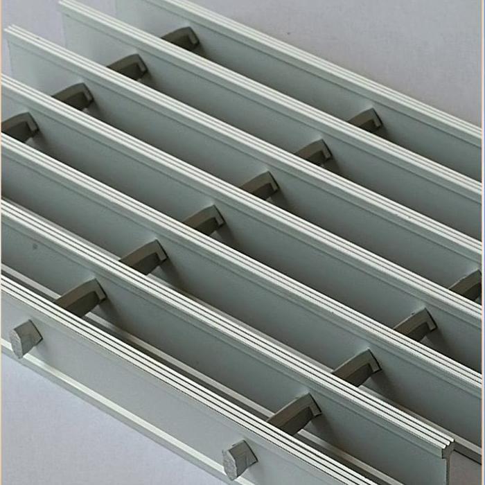 Close-up of square cross bars mechanically locked through aluminum bearing-bar profiles