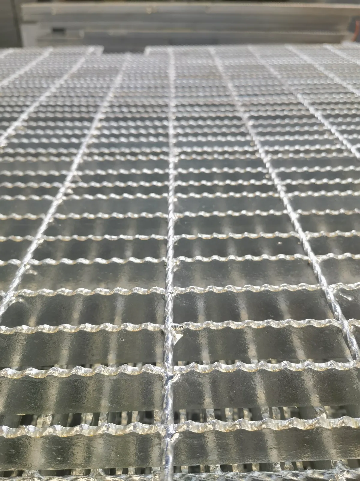 Close-up of serrated hot-dip galvanized grating bearing bars