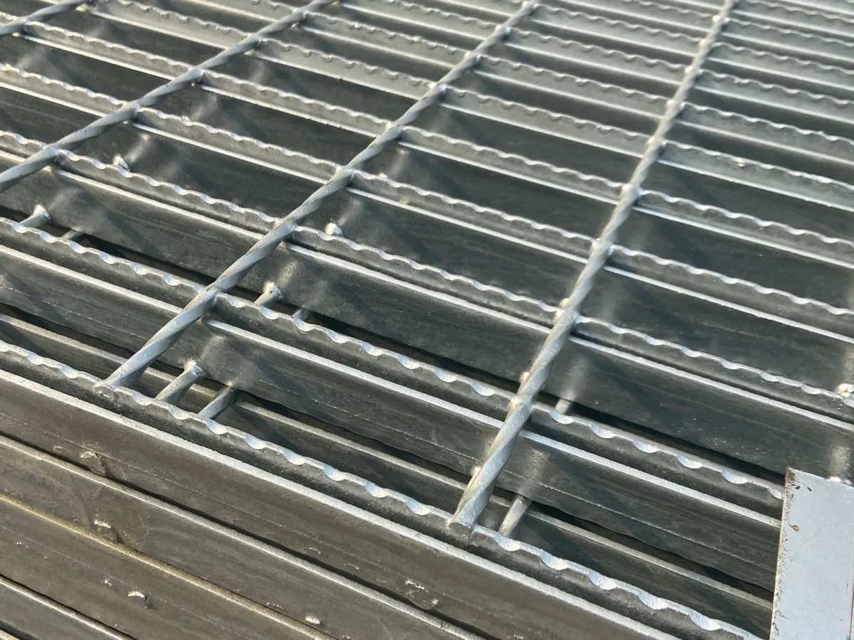 Close-up of serrated bearing bars on galvanized welded steel grating