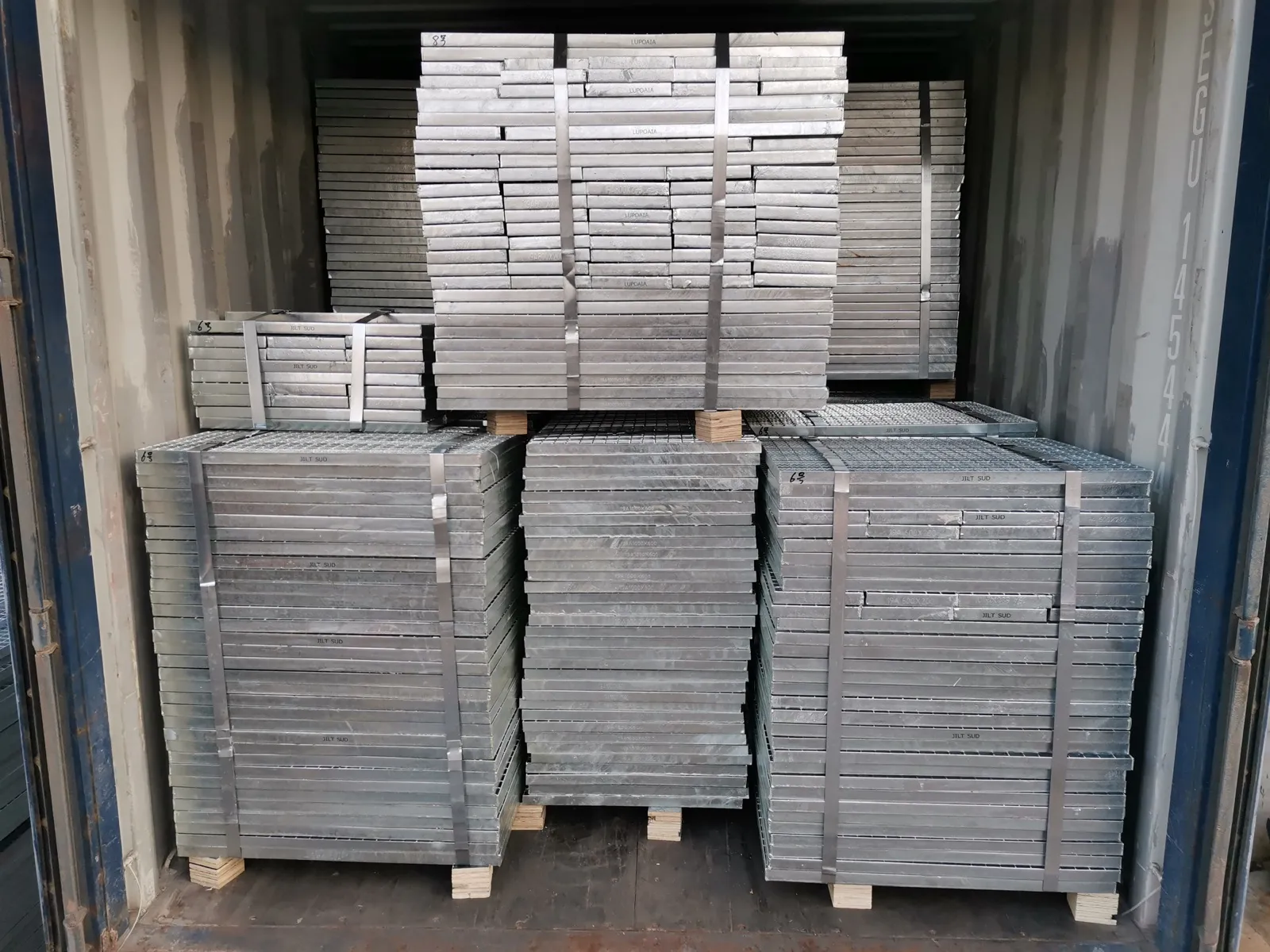 Strapped steel grating bundles loaded inside a 20 foot shipping container