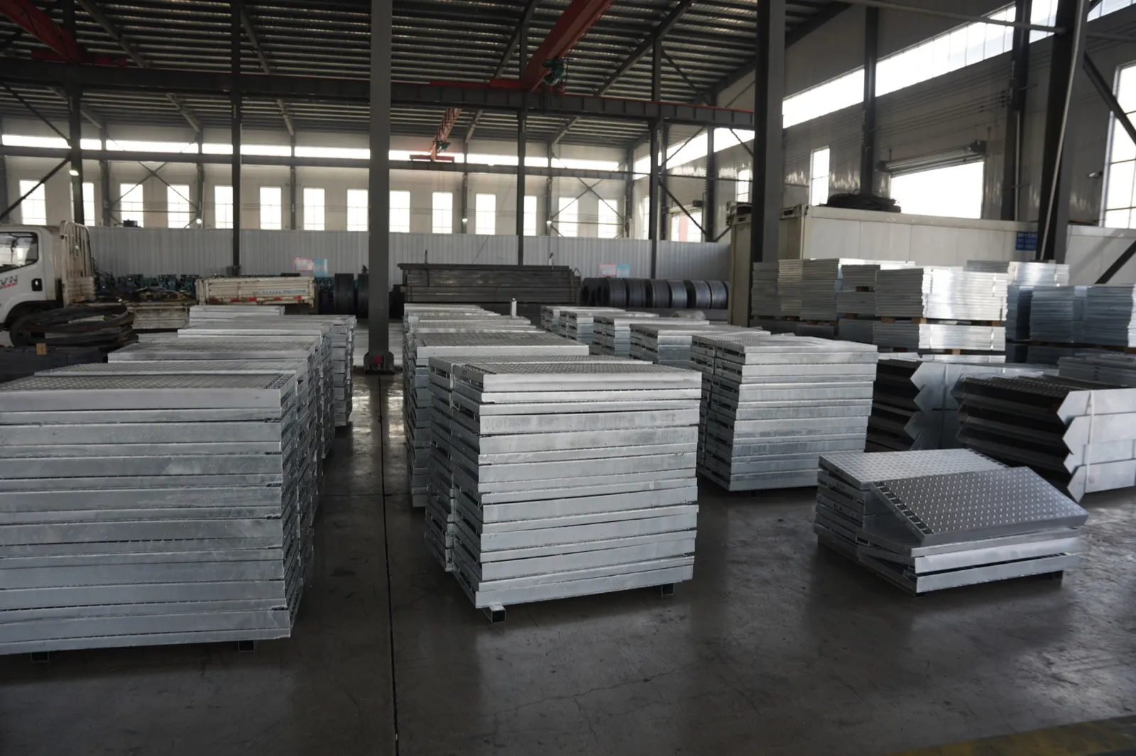Galvanized grating panels staged under cover inside the factory before packing