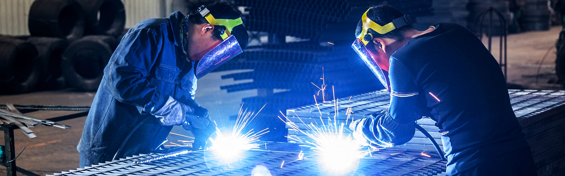 Workers welding steel grating panels in the DONGFU workshop