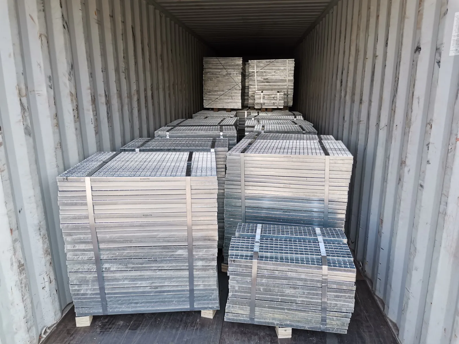 Galvanized steel grating panels bundled and loaded inside an export container