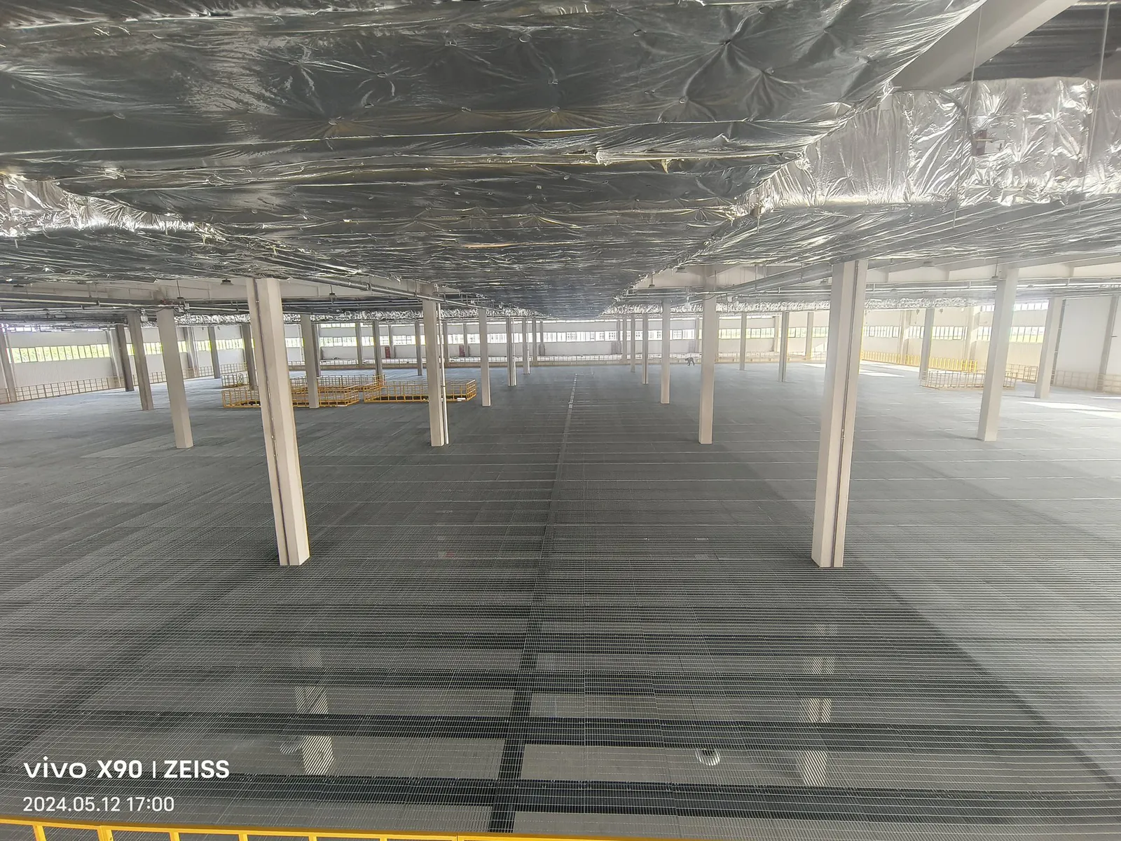 Finished steel grating platform floor below the logistics work level