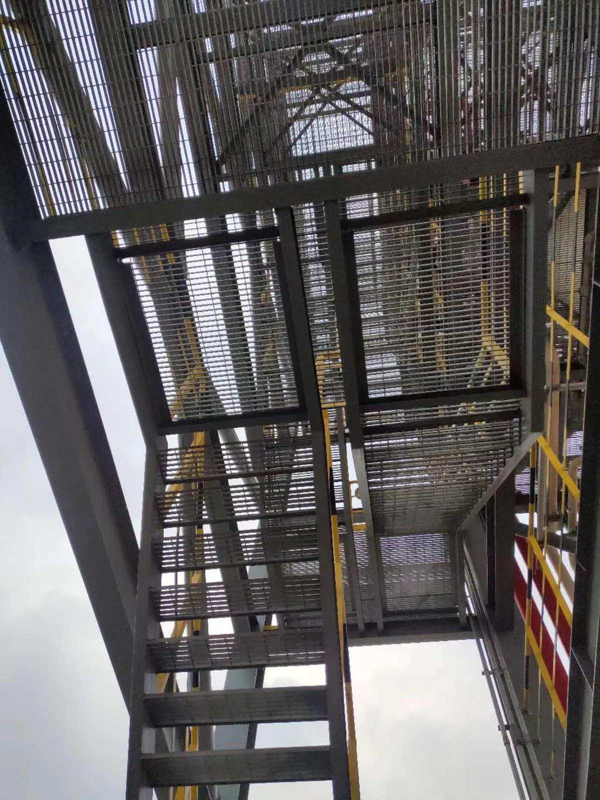 Underside view of stacked steel grating platform levels