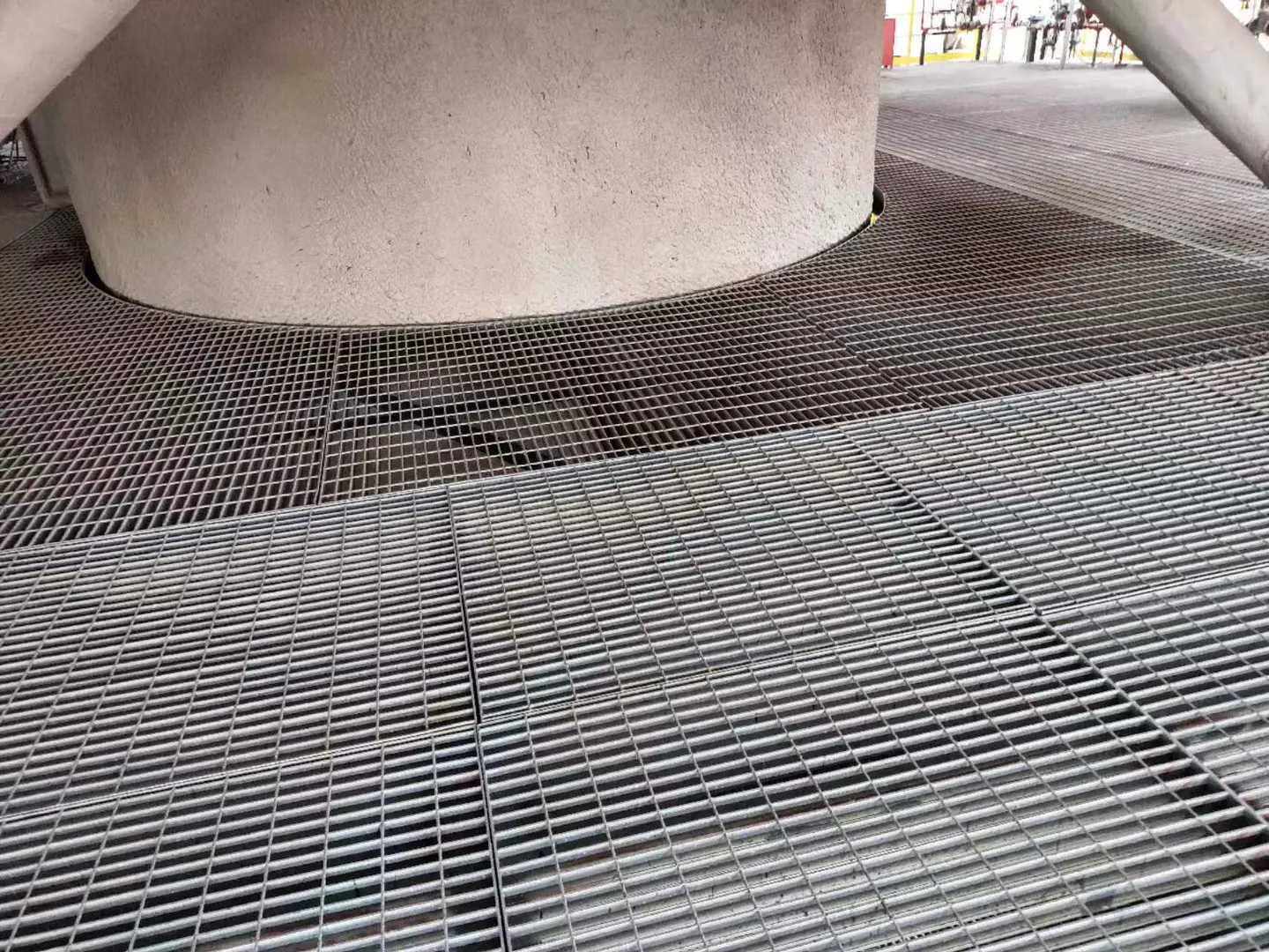 Custom steel grating fitted around a circular equipment base