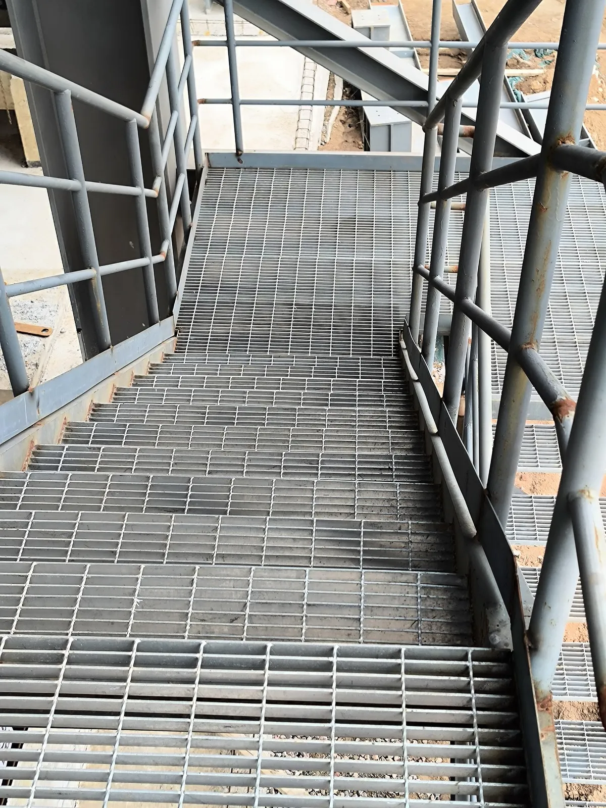 Steel grating stair treads and intermediate landing in the chemical unit