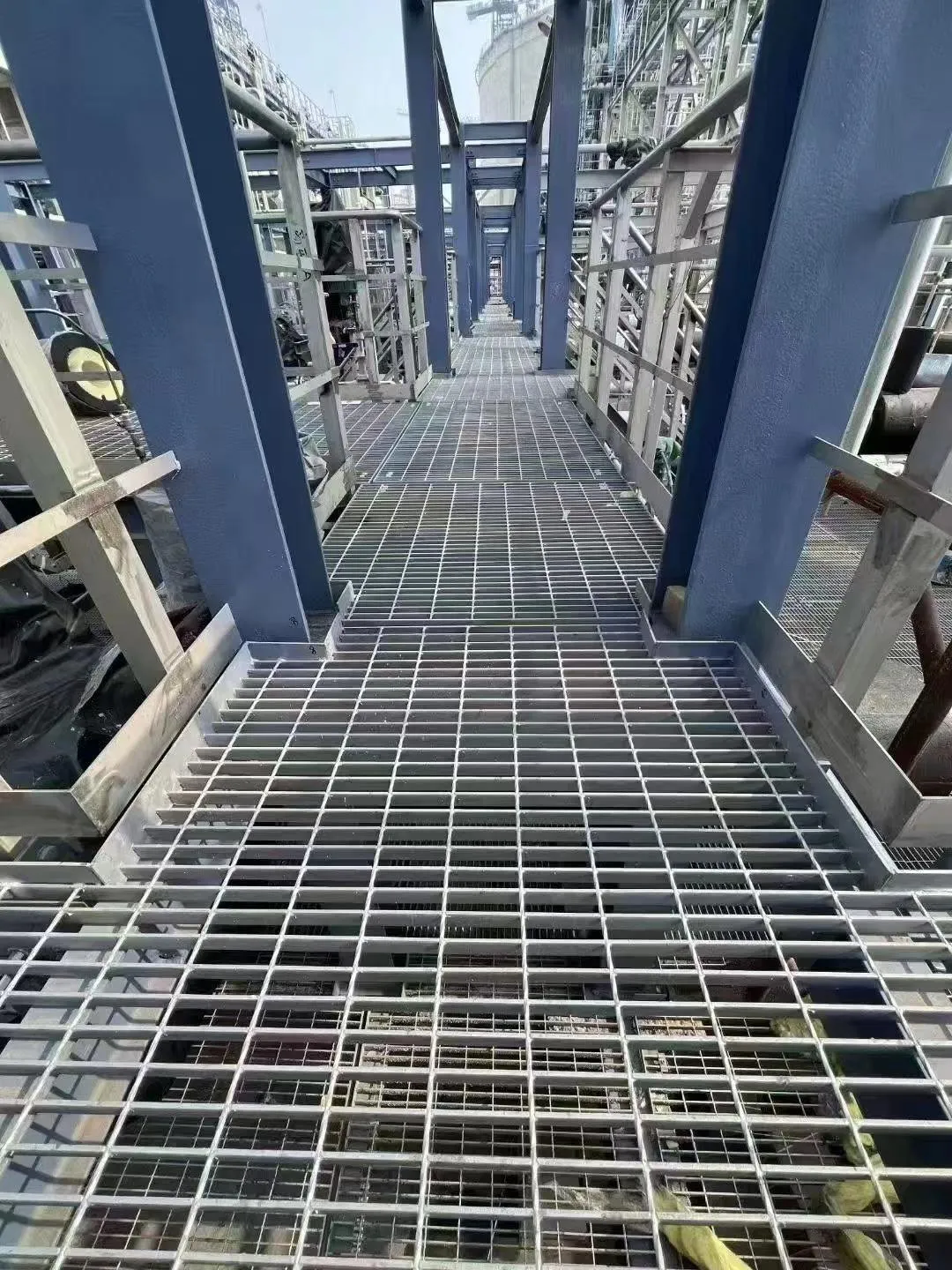 Steel grating maintenance walkway through a multi-level industrial structure